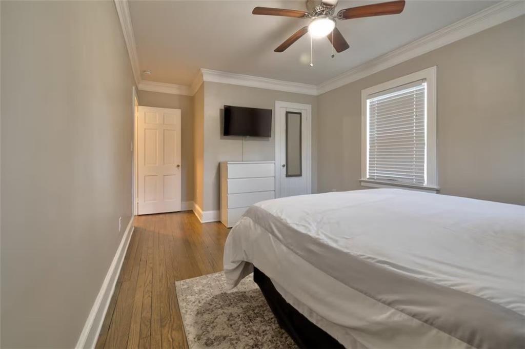 1074 Jefferson Avenue East Point, GA 30344 - Photo 6 of 13 a spacious bedroom with a bed and a flat screen tv