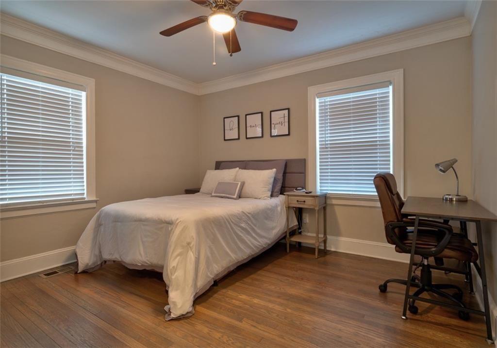 1074 Jefferson Avenue East Point, GA 30344 - Photo 7 of 13 a bedroom with a large bed and a desk