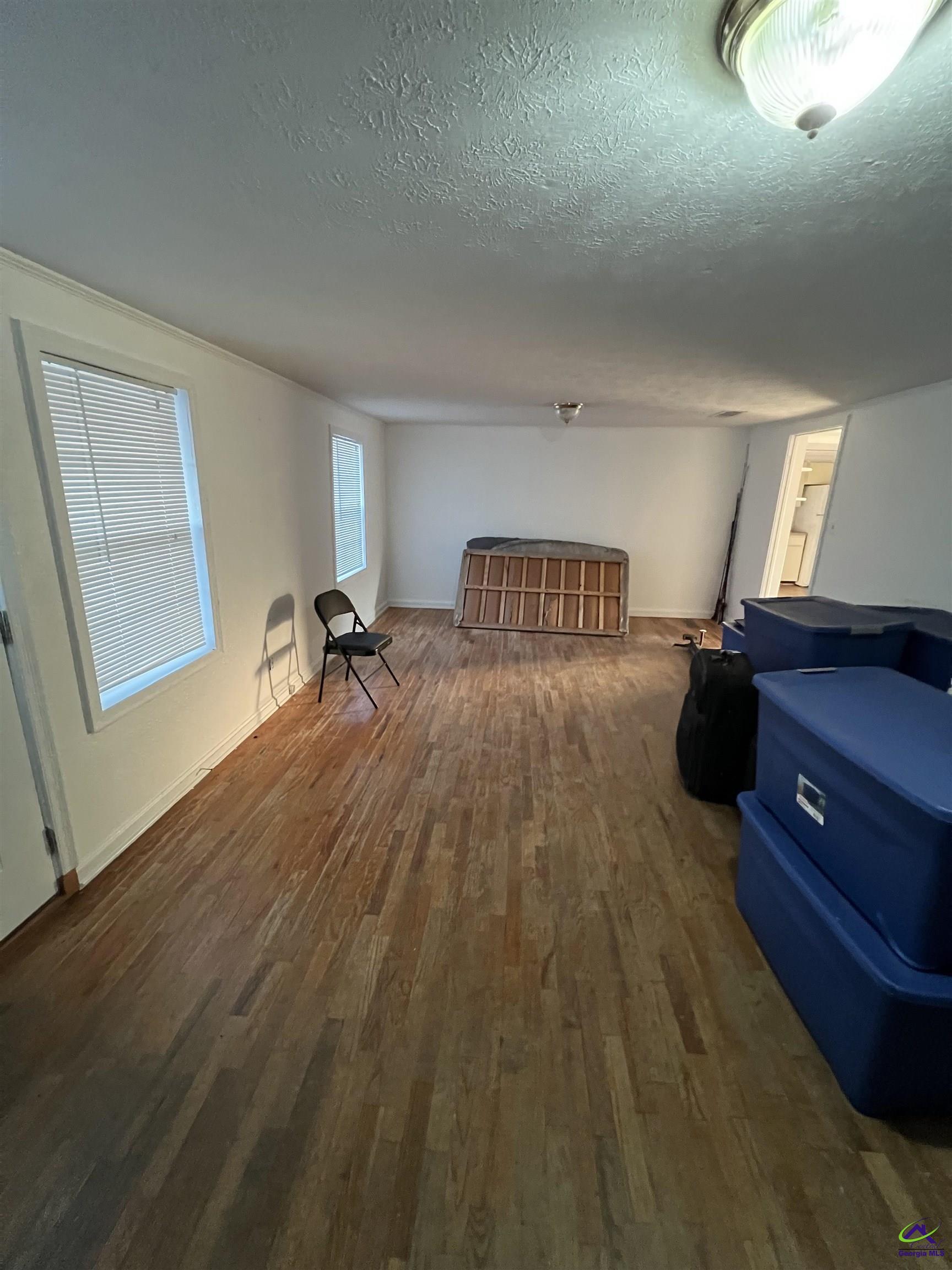 3281 State Rte 126 Dublin, GA 31021 - Photo 11 of 22 a bedroom with a bed and wooden floor