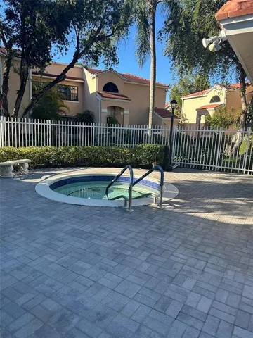 a view of a park with a bench and wooden fence