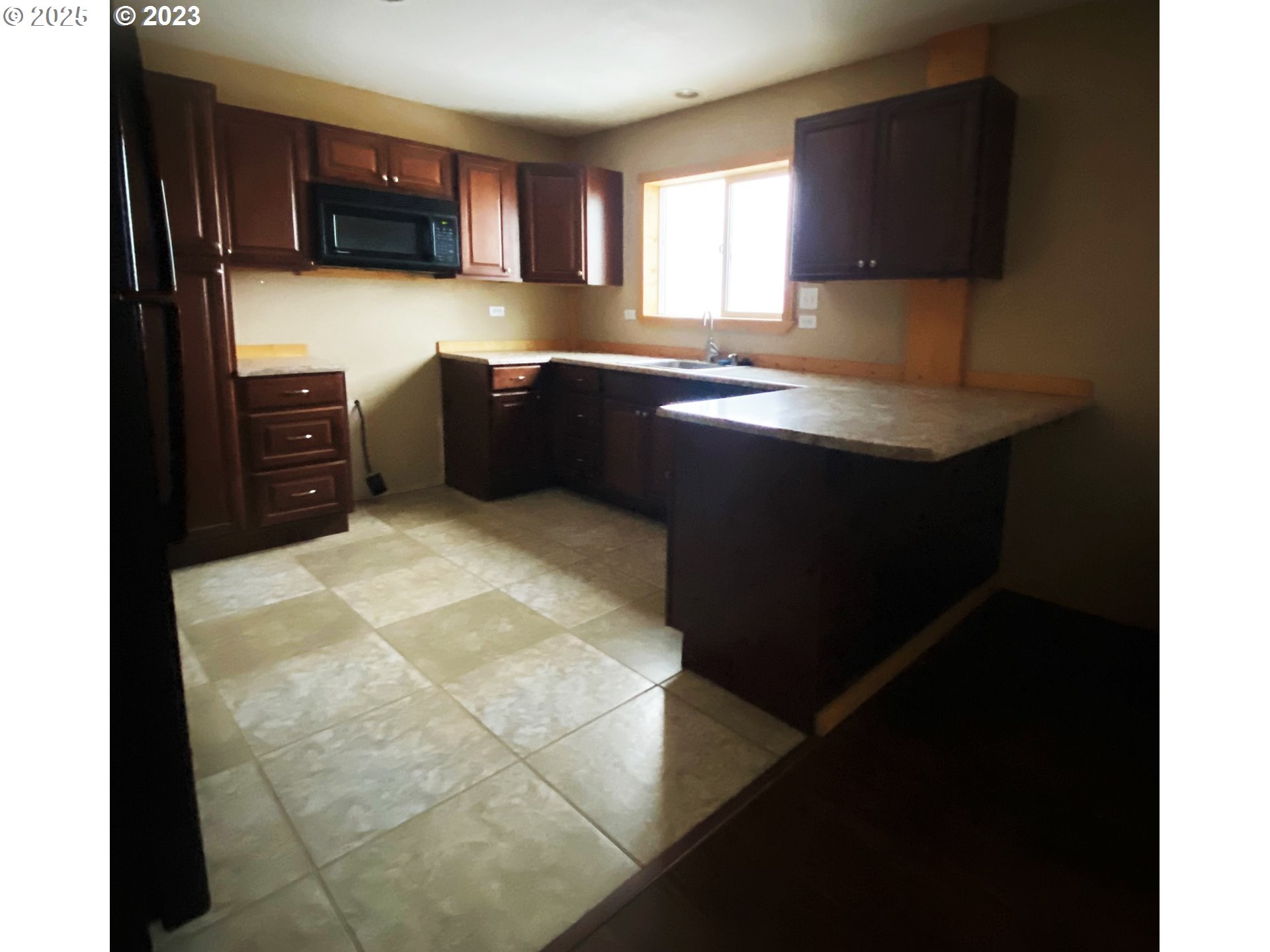 43768 Sunnyslope Road Baker City, OR 97814 - Photo 13 of 22 a kitchen with granite countertop a sink cabinets and a window