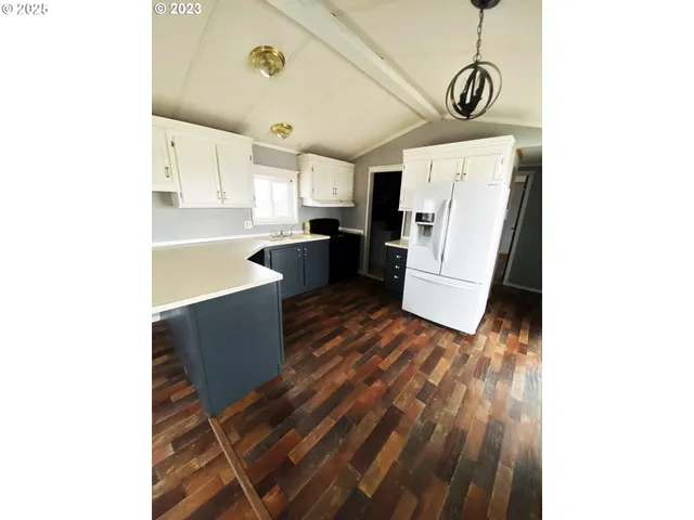 a kitchen with granite countertop white cabinets and black appliances