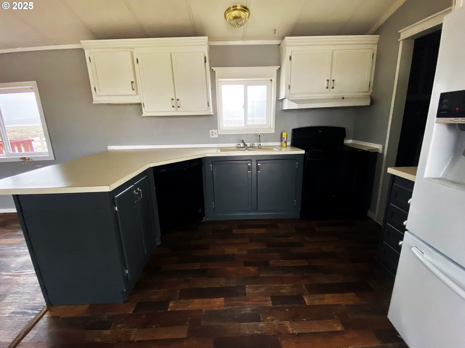 43768 Sunnyslope Road Baker City, OR 97814 - Photo 7 of 22 a kitchen with granite countertop white cabinets and black appliances
