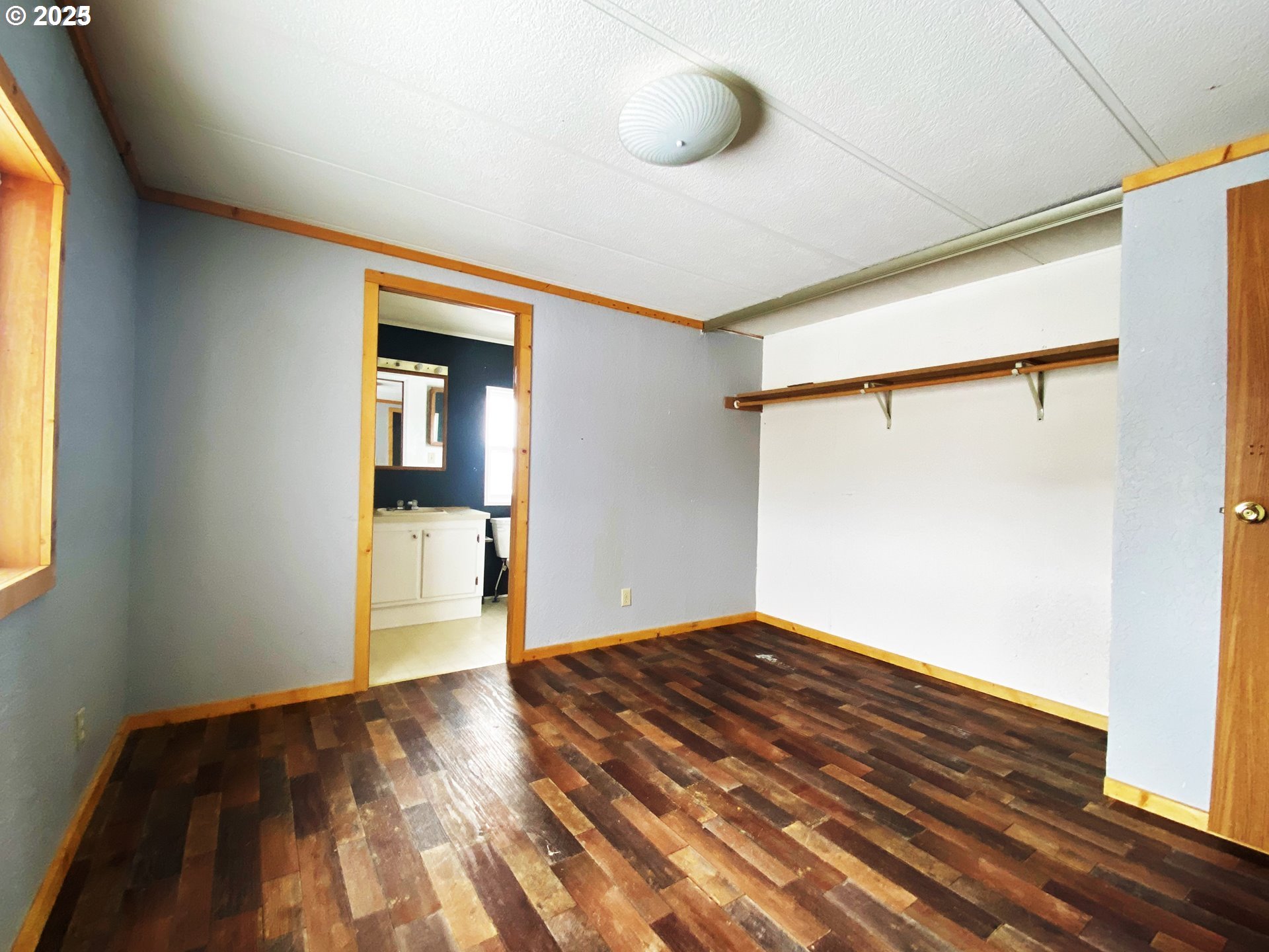 43768 Sunnyslope Road Baker City, OR 97814 - Photo 8 of 22 a view of an empty room with wooden floor and a window