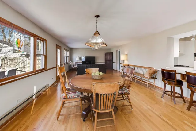 a view of a dining room with furniture window and wooden floor