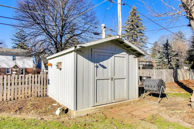 a view of a house with wooden fence
