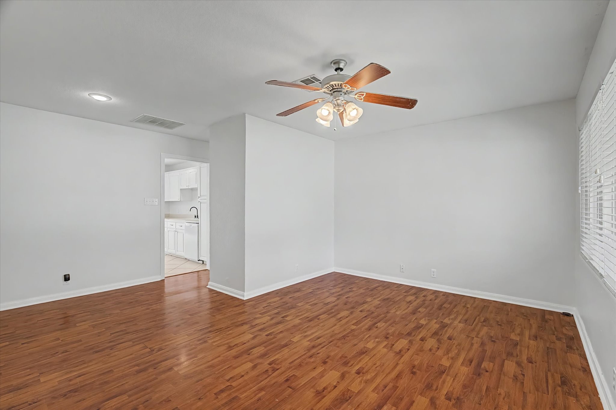 413 Farrer Street Angleton, TX 77515 - Photo 4 of 43 wooden floor in an empty room with a window