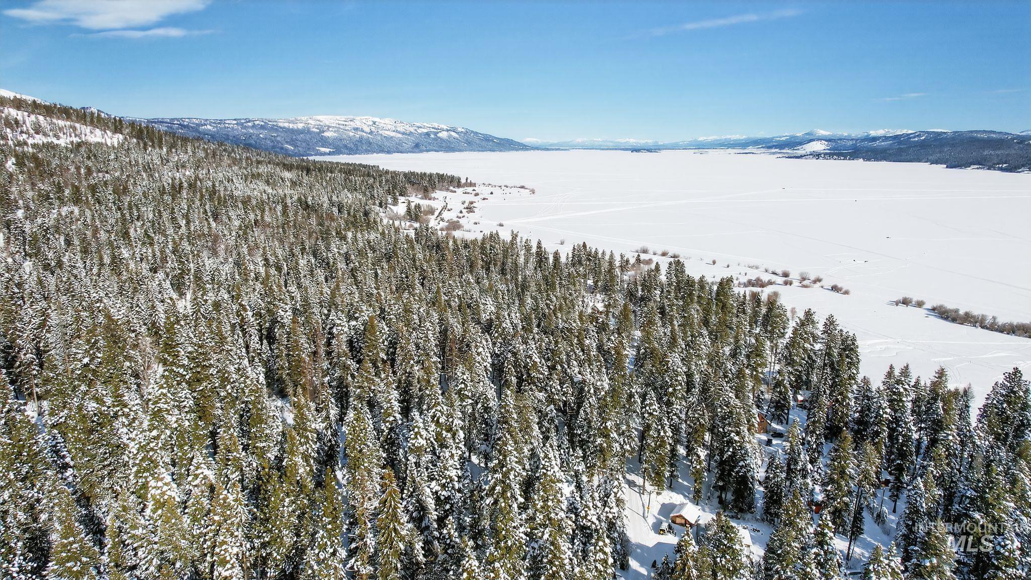 654 Bings Road Cascade, ID 83611 - Photo 33 of 40 Snowy aerial view featuring a mountain view