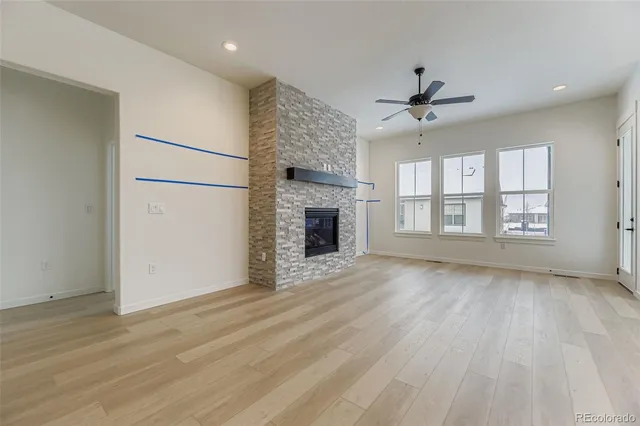 a view of a kitchen with wooden floor and a kitchen space