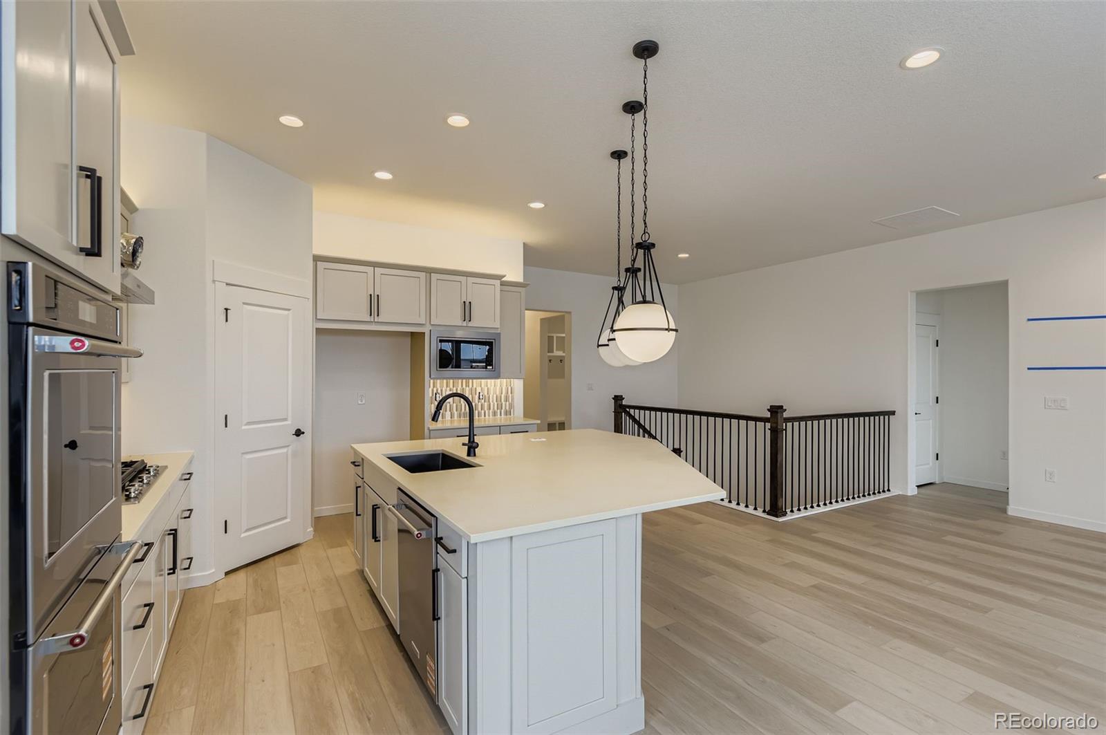 8895 South Riviera Way Aurora, CO 80016 - Photo 10 of 26 a kitchen with stainless steel appliances granite countertop a sink a stove and a refrigerator