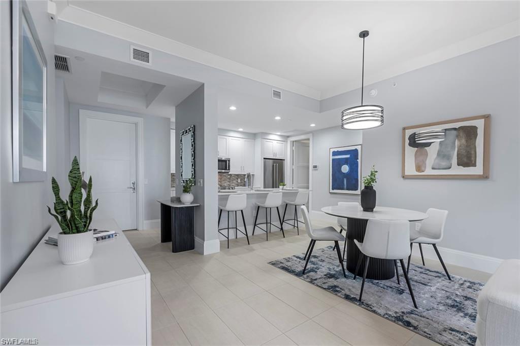 1030 3rd Avenue South, Unit 315 Naples, FL 34102 - Photo 12 of 29 a view of a dining room with furniture