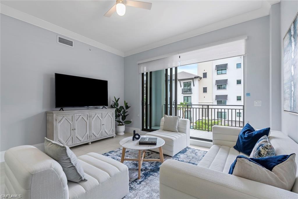 1030 3rd Avenue South, Unit 315 Naples, FL 34102 - Photo 13 of 29 a living room with furniture and a flat screen tv