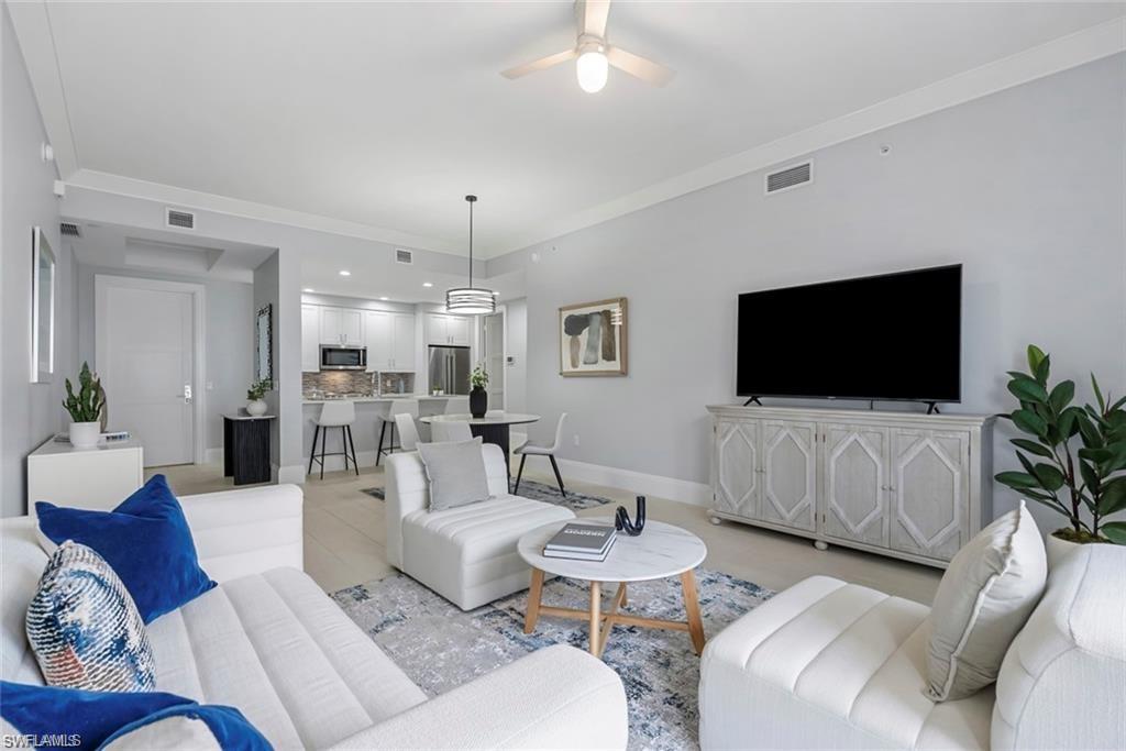 1030 3rd Avenue South, Unit 315 Naples, FL 34102 - Photo 14 of 29 a living room with furniture and a flat screen tv