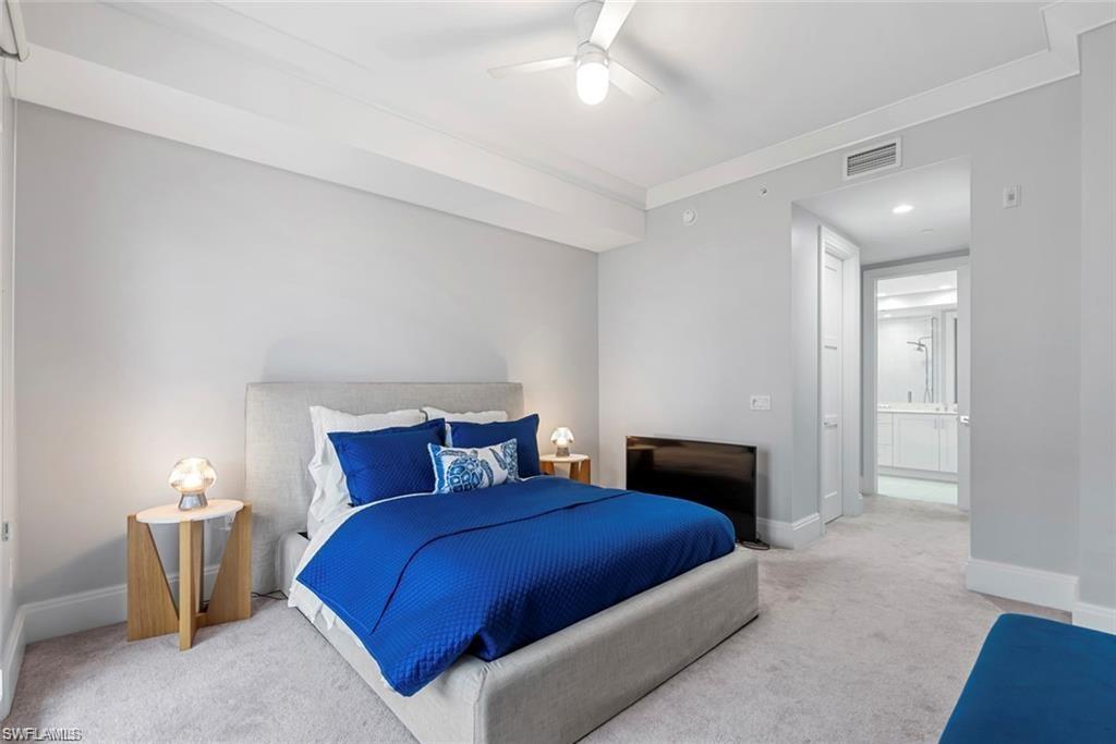 1030 3rd Avenue South, Unit 315 Naples, FL 34102 - Photo 19 of 29 a bedroom with a bed and a lamp