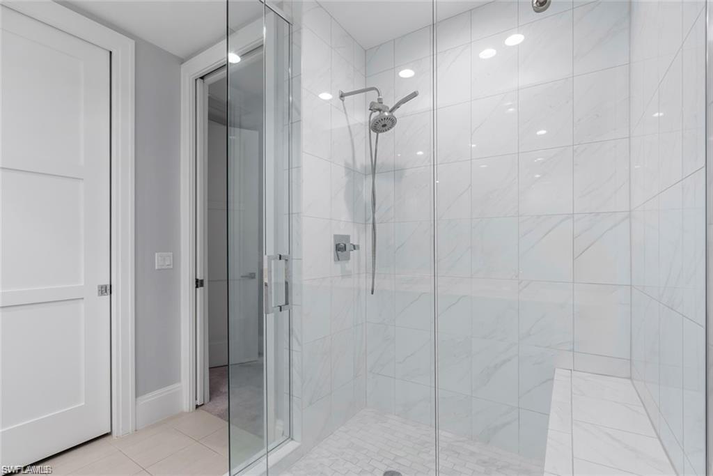 1030 3rd Avenue South, Unit 315 Naples, FL 34102 - Photo 21 of 29 a bathroom with a shower and a glass door