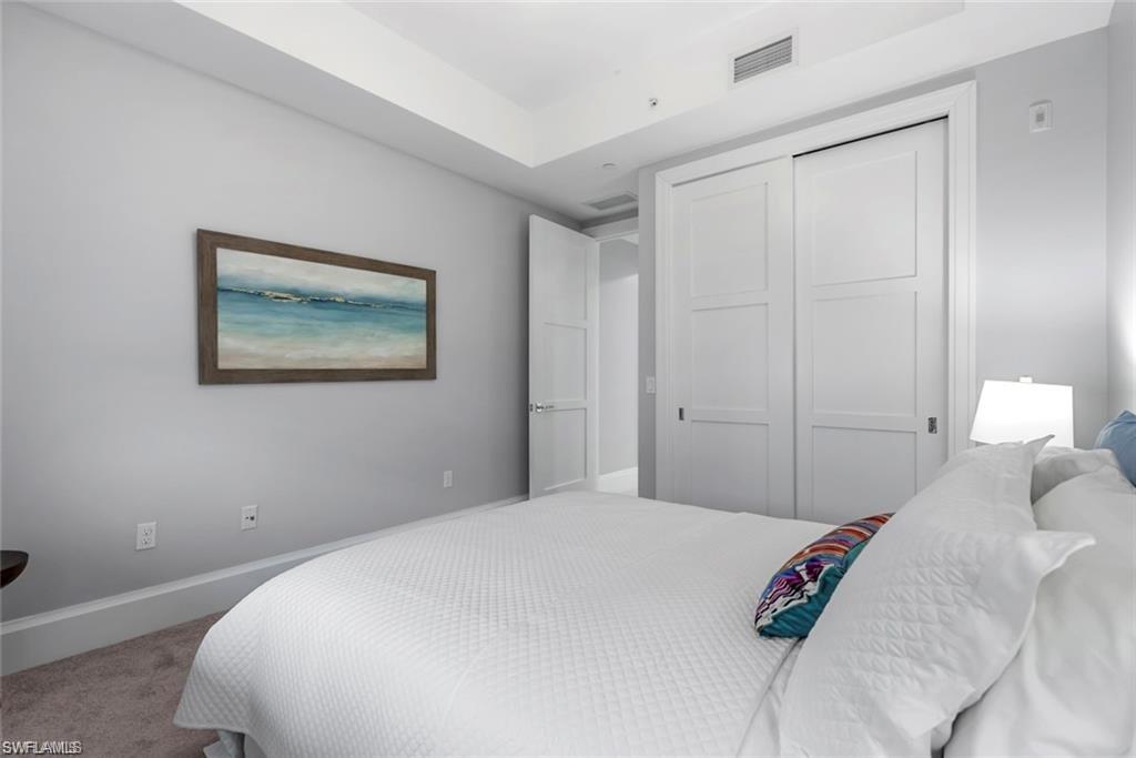 1030 3rd Avenue South, Unit 315 Naples, FL 34102 - Photo 23 of 29 a bedroom with a bed and a painting on the wall