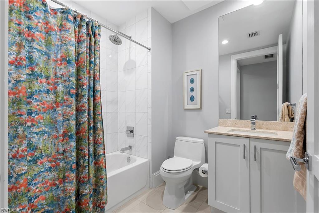 1030 3rd Avenue South, Unit 315 Naples, FL 34102 - Photo 24 of 29 a bathroom with a sink a toilet and shower curtain
