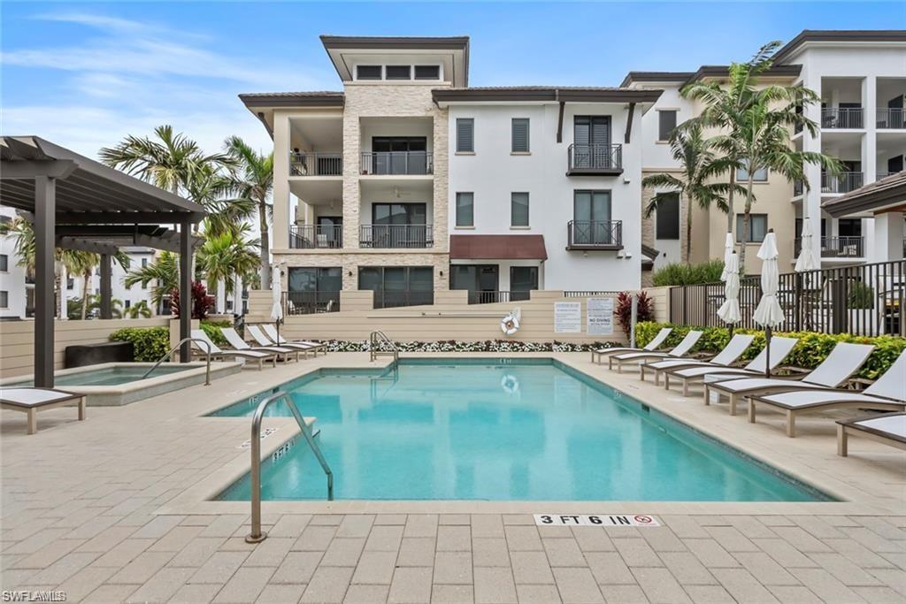 1030 3rd Avenue South, Unit 315 Naples, FL 34102 - Photo 26 of 29 a swimming pool with outdoor seating and yard