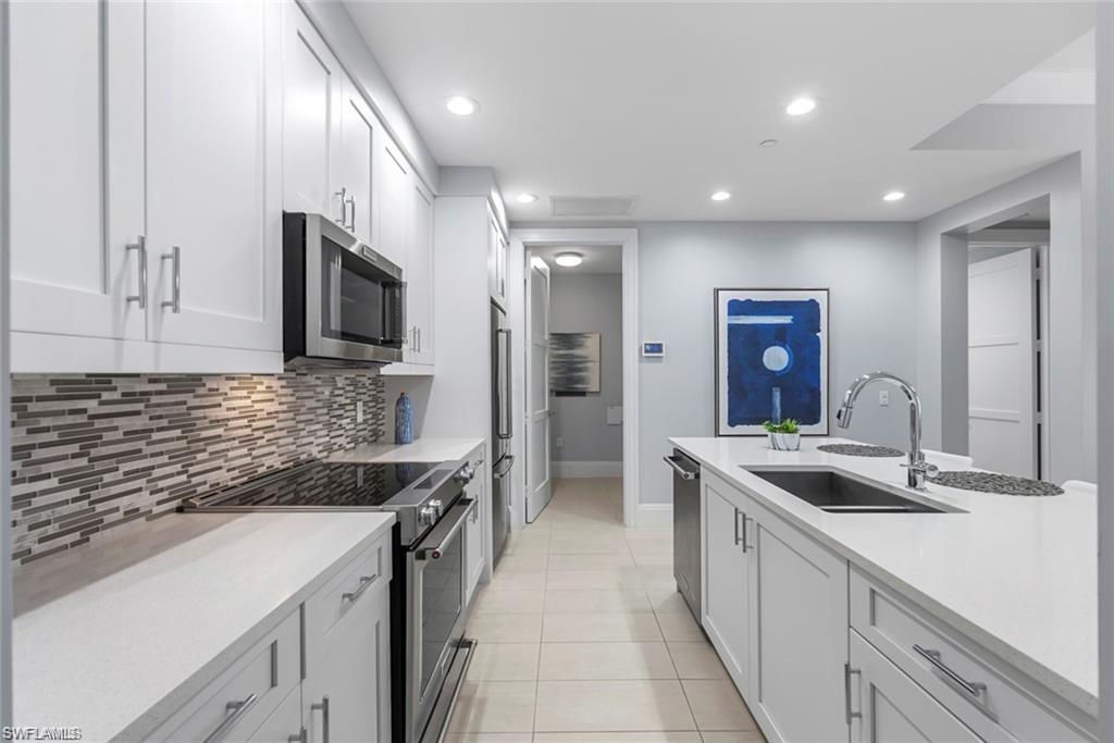 1030 3rd Avenue South, Unit 315 Naples, FL 34102 - Photo 10 of 29 a kitchen with a sink appliances and cabinets