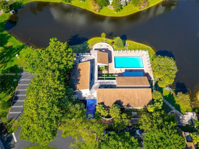 an aerial view of a house with a yard and swimming pool