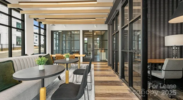 a view of a dining room with furniture and window