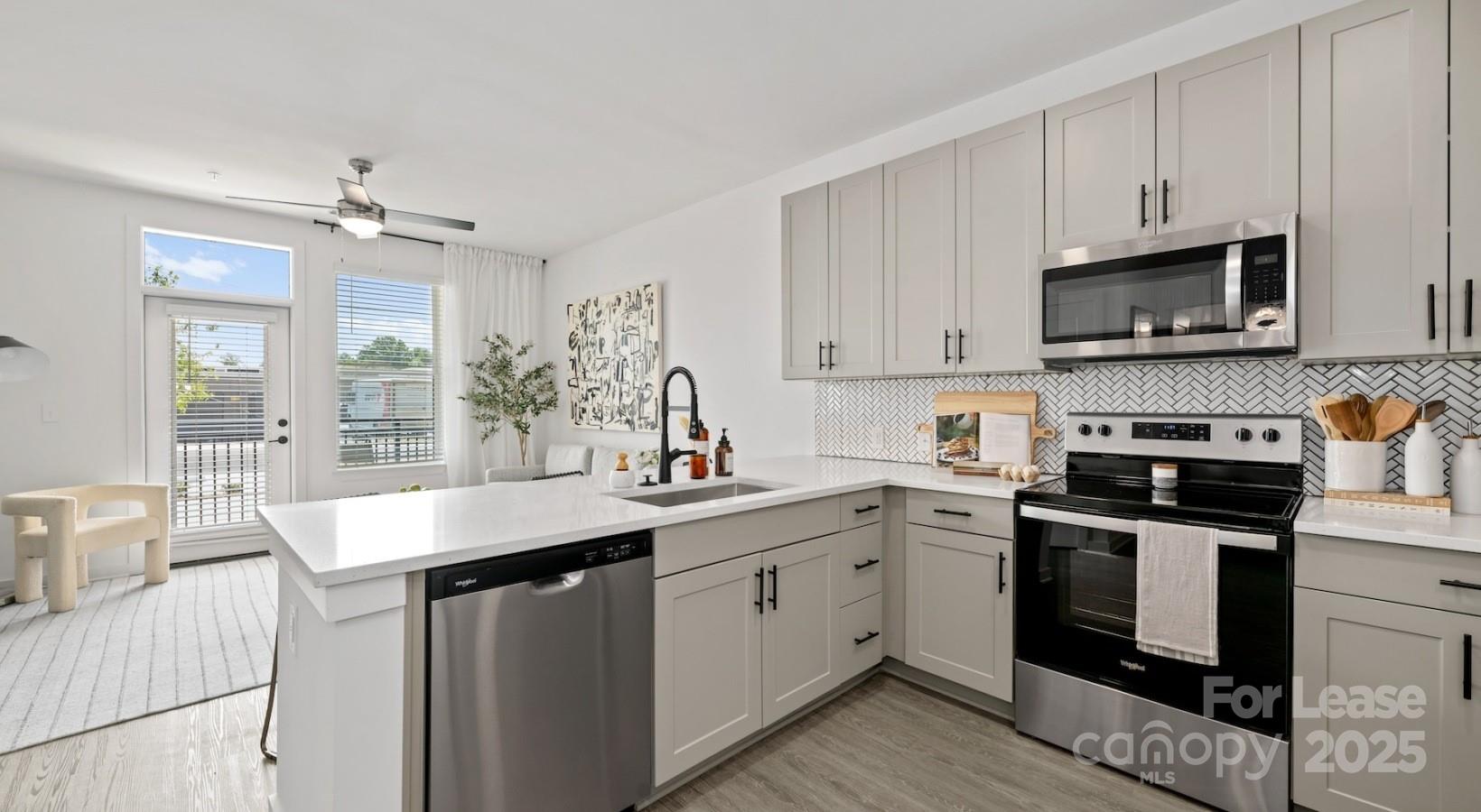 2314 Berryhill Road, Unit 1M Charlotte, NC 28208 - Photo 20 of 31 a kitchen with stainless steel appliances granite countertop a sink stove and cabinets