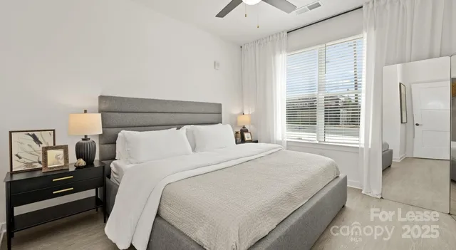 a bedroom with a bed and a night stand