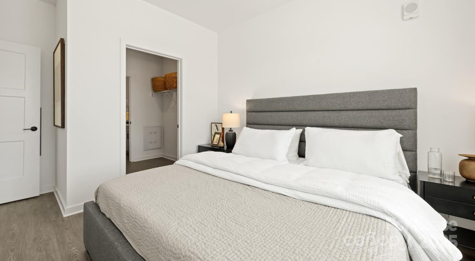 2314 Berryhill Road, Unit 1M Charlotte, NC 28208 - Photo 26 of 31 a bedroom with a bed and a night stand