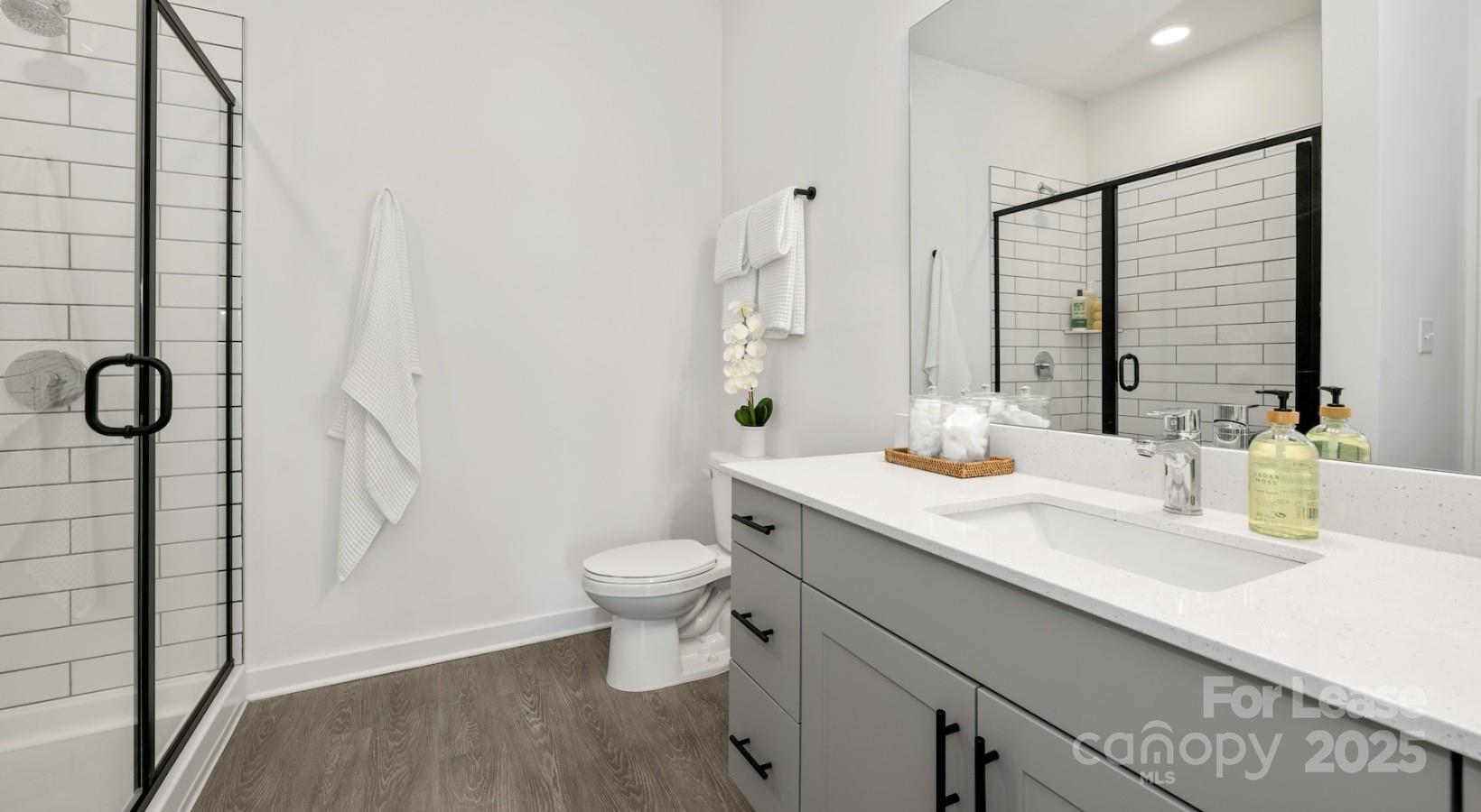 2314 Berryhill Road, Unit 1M Charlotte, NC 28208 - Photo 27 of 31 a bathroom with a sink a toilet and shower