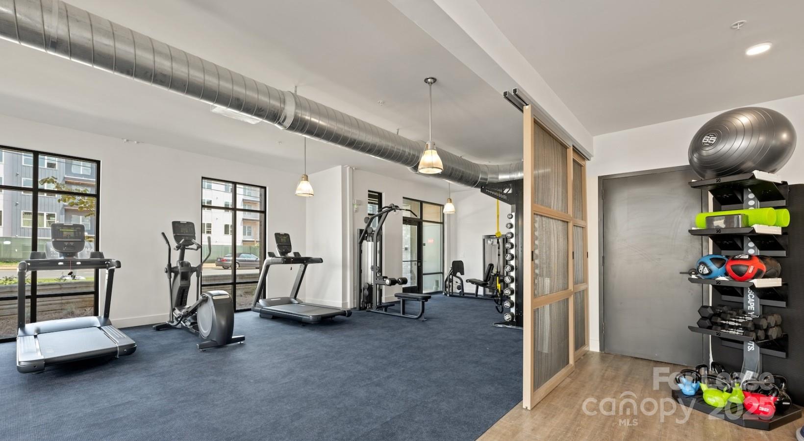2314 Berryhill Road, Unit 1M Charlotte, NC 28208 - Photo 6 of 31 a view of game room with gym equipment