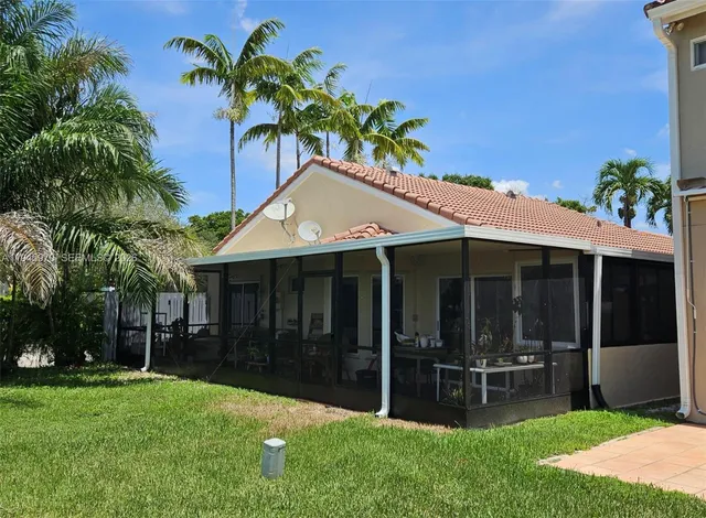 a backyard of a house with table and chairs