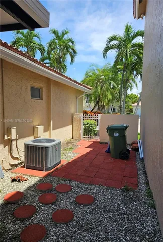 a view of a house with yard and sitting area