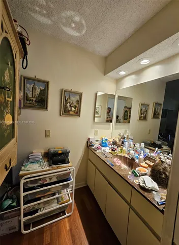 a kitchen with stainless steel appliances kitchen island granite countertop a stove and cabinets