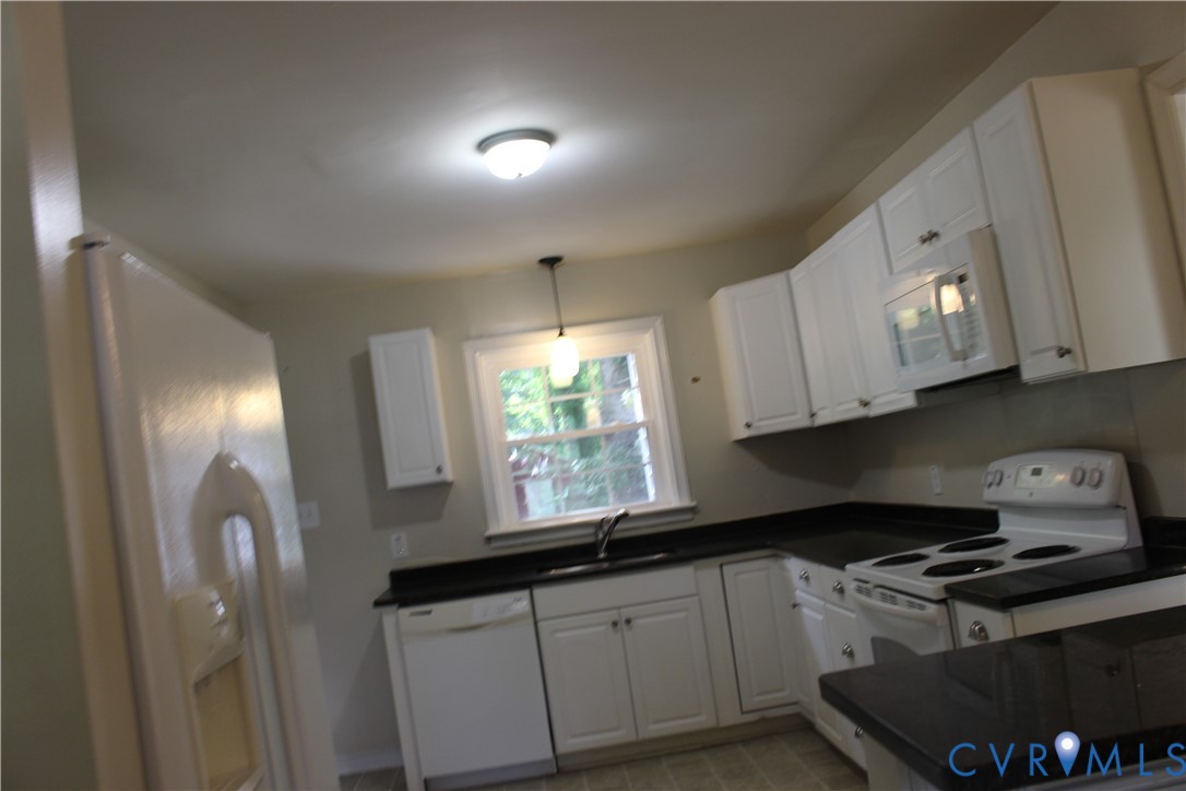 10035 Wycliff Road Chesterfield, VA 23236 - Photo 9 of 12 White cabinetry with dark countertops, a built-in