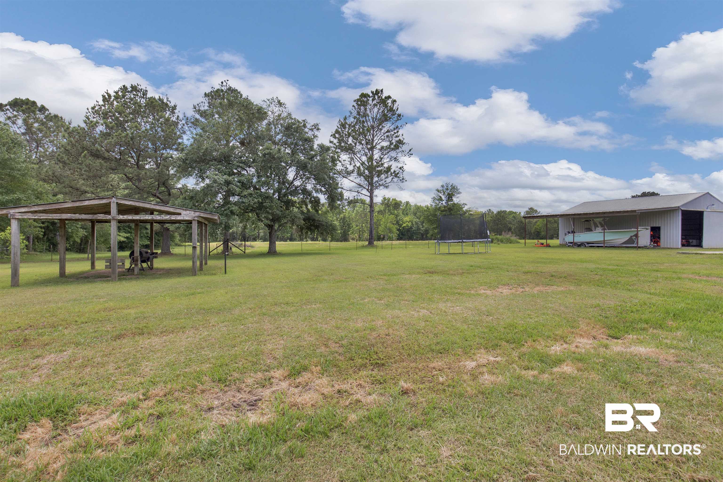 13925 Fort Lake Road Grand Bay, AL 36541 - Photo 24 of 37 View of yard featuring a trampoline and a detached carport