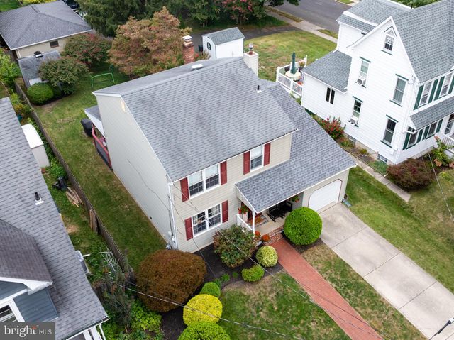 an aerial view of a house with garden space and street view