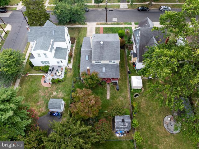 an aerial view of residential houses with outdoor space and trees