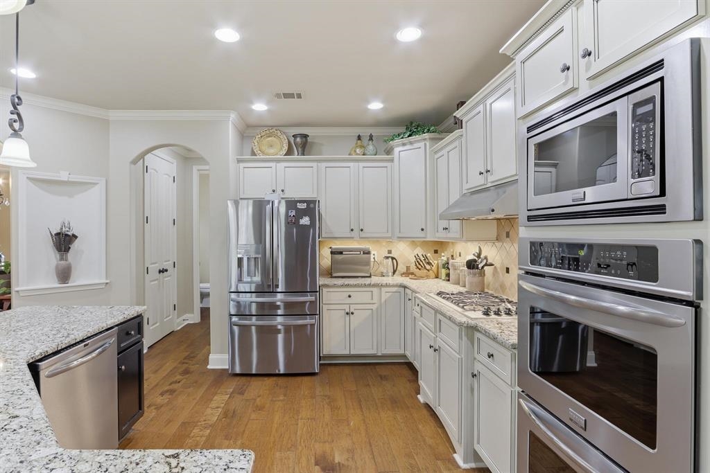 1301 Conser Street Collierville, TN 38017 - Photo 9 of 39 a kitchen with stainless steel appliances a stove a sink and a refrigerator