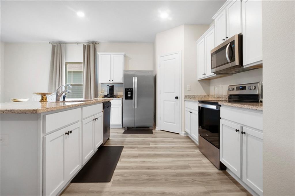 217 Limestone Circle Conyers, GA 30013 - Photo 11 of 21 a kitchen with stainless steel appliances a refrigerator sink and microwave