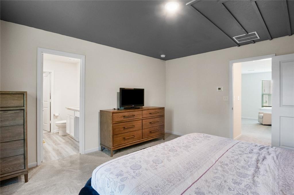 217 Limestone Circle Conyers, GA 30013 - Photo 15 of 21 a bedroom with a bed and flat screen tv