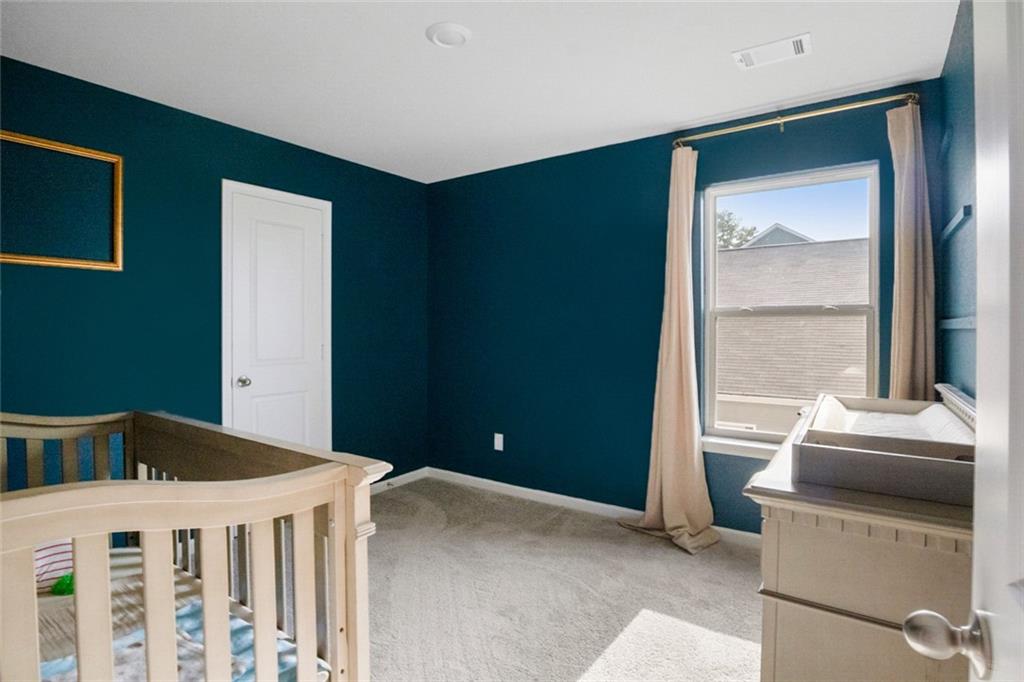 217 Limestone Circle Conyers, GA 30013 - Photo 20 of 21 a bedroom with a bed and a window