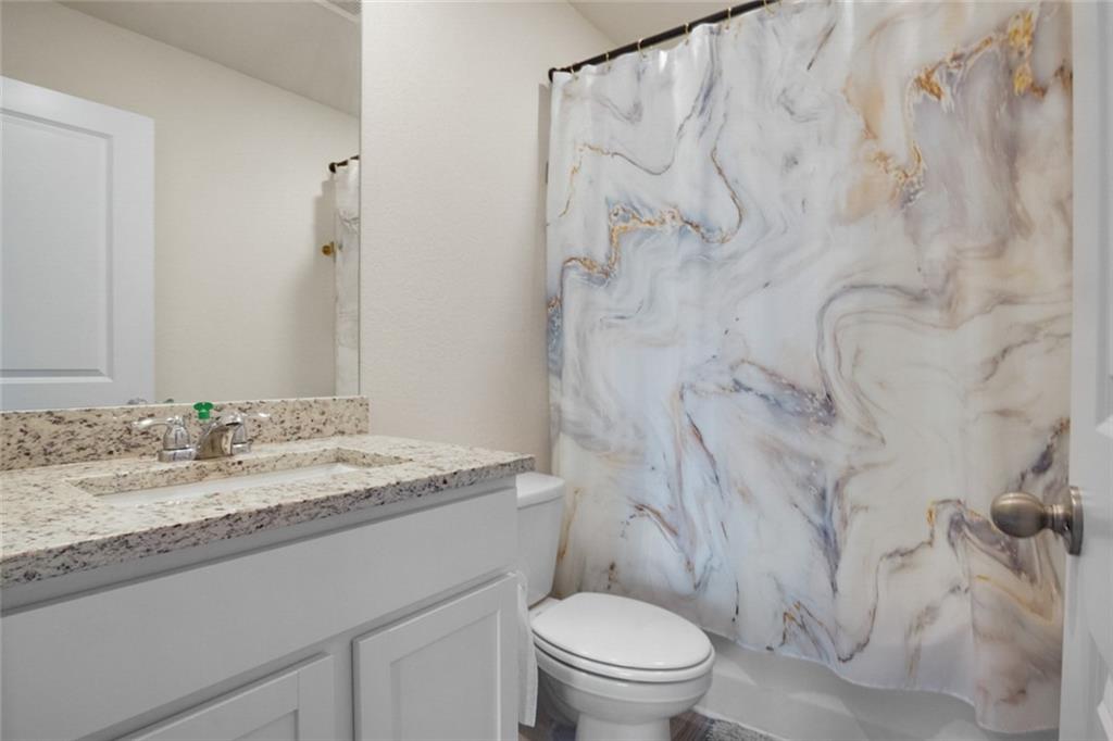 217 Limestone Circle Conyers, GA 30013 - Photo 21 of 21 a bathroom with a granite countertop sink toilet and shower