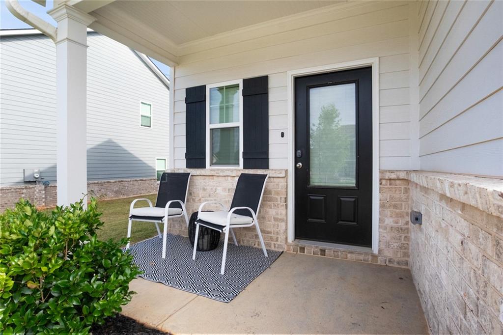 217 Limestone Circle Conyers, GA 30013 - Photo 3 of 21 a patio with table and chairs and potted plants