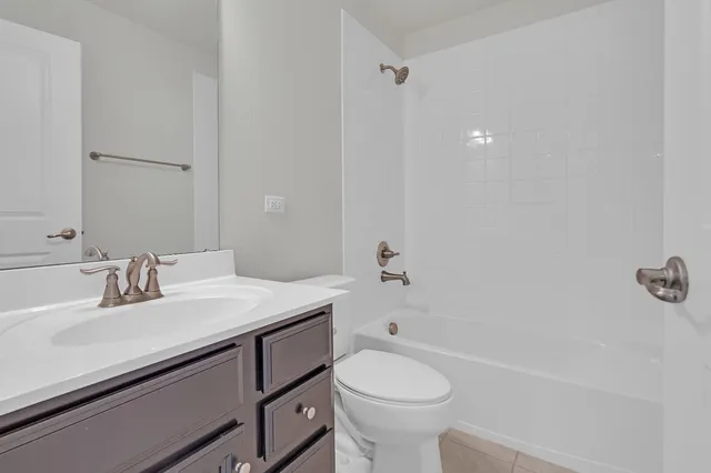a bathroom with a sink toilet vanity and tub