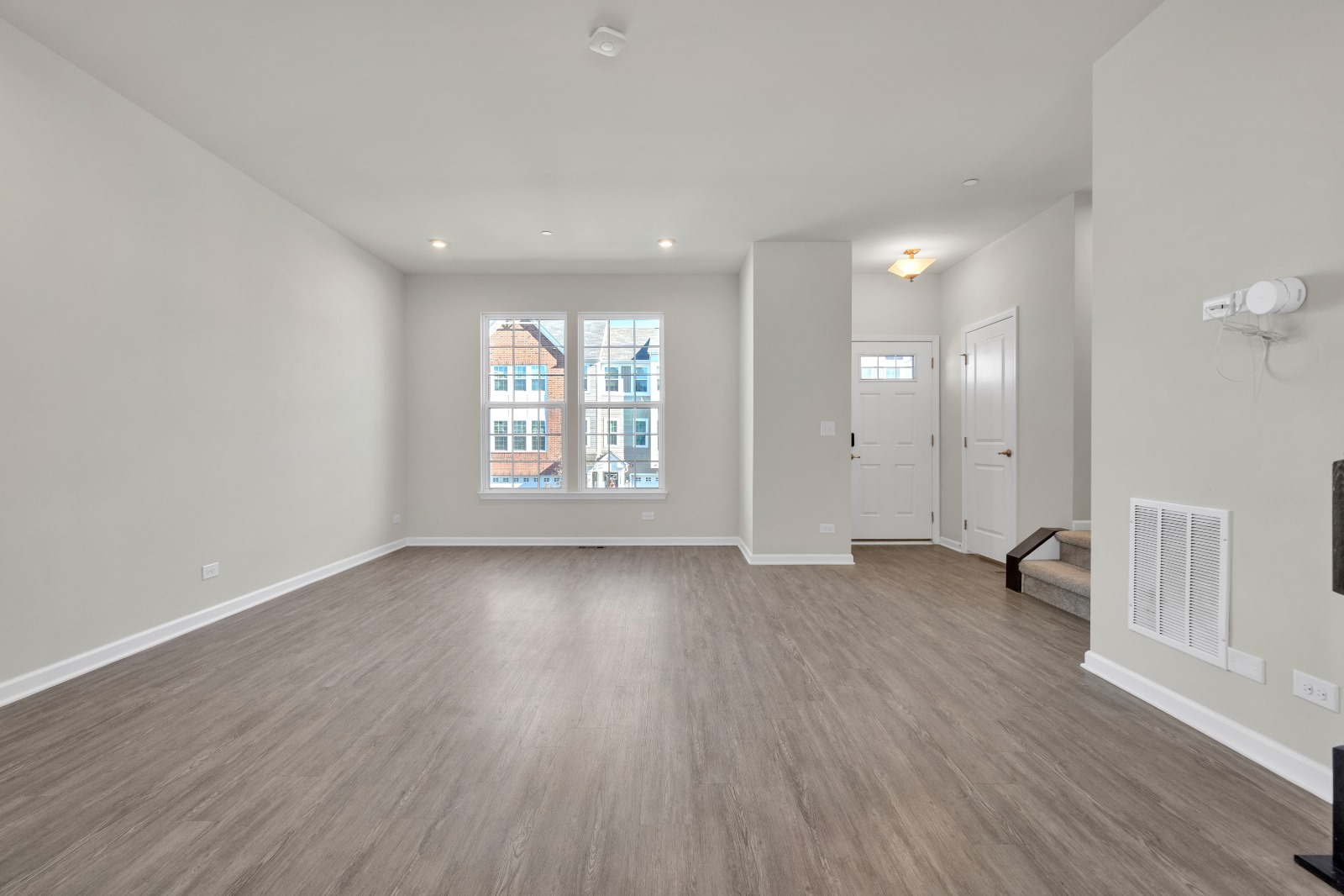 773 Rockwell Lane Des Plaines, IL 60016 - Photo 2 of 22 an empty room with wooden floor and windows