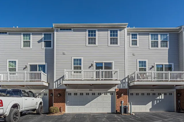 a front view of a house with a parking space