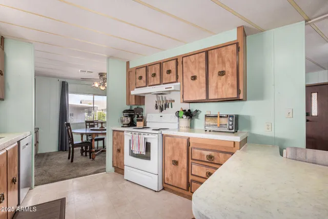 a kitchen with stainless steel appliances kitchen island granite countertop a sink and cabinets