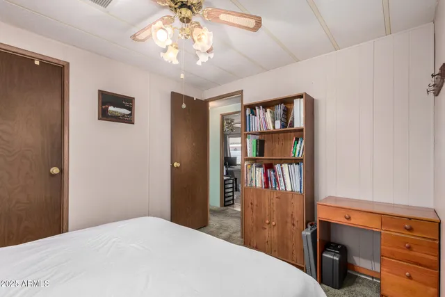 a bedroom with a bed and a book shelf