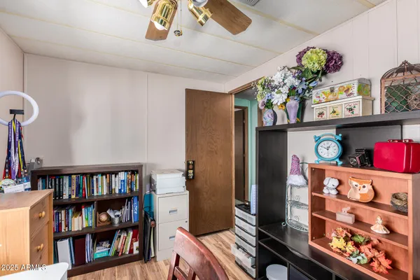 a bedroom with a bed and a book shelf