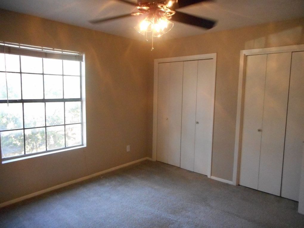 3106 Cedar Street Austin, TX 78705 - Photo 15 of 19 Unfurnished bedroom with multiple closets, carpet flooring, and ceiling fan